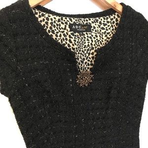 Black Formal Cocktail Dress with Gold Medallion.